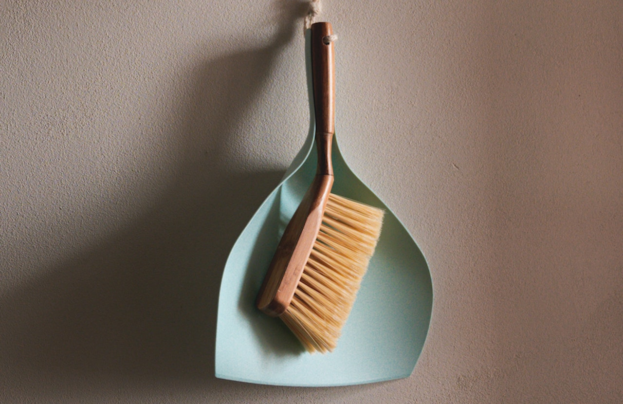 Data processing. Picture of dust pan hanging on a wall. Photo by Jan Kopriva on Unsplash.